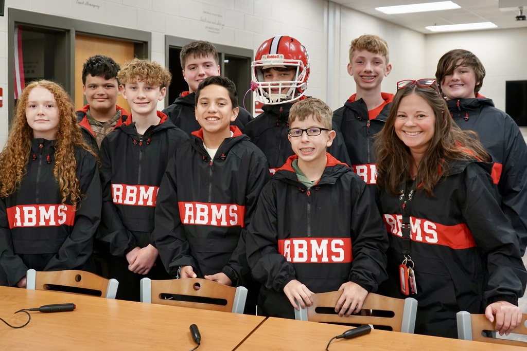 A group of students wearing a red and black pullover.