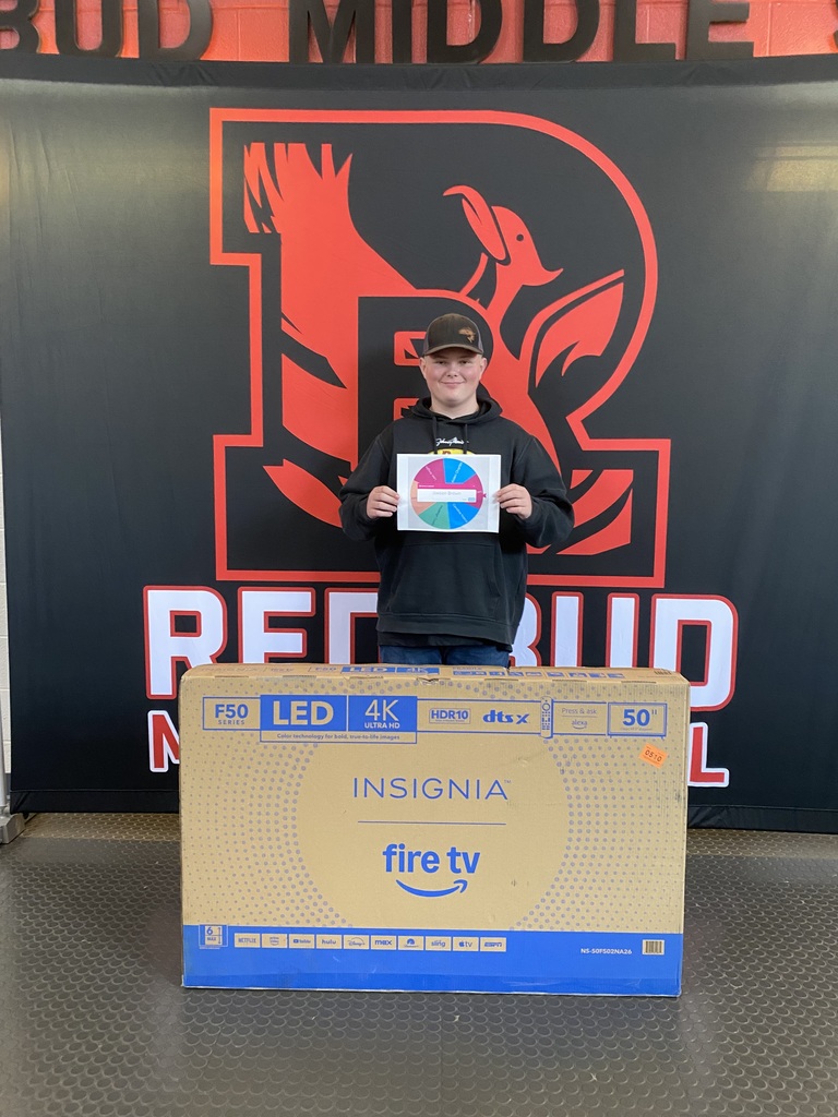 boy standing with his TV he won