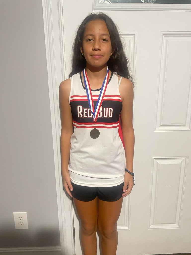 Girl standing with a medal