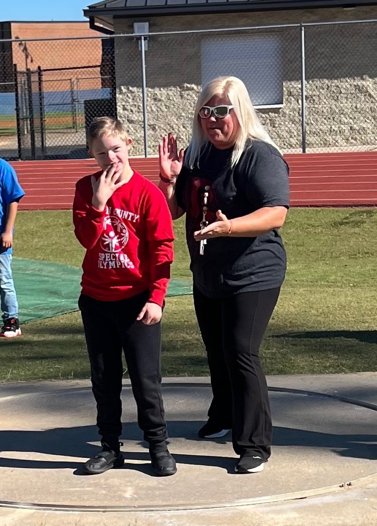 One boy in a red shirt and a woman in a gray shirt.