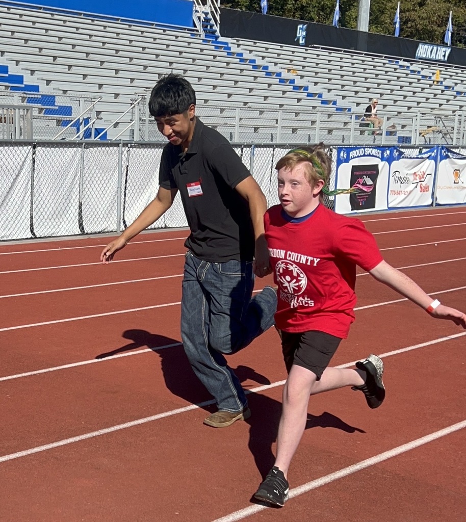 two boys running on a track