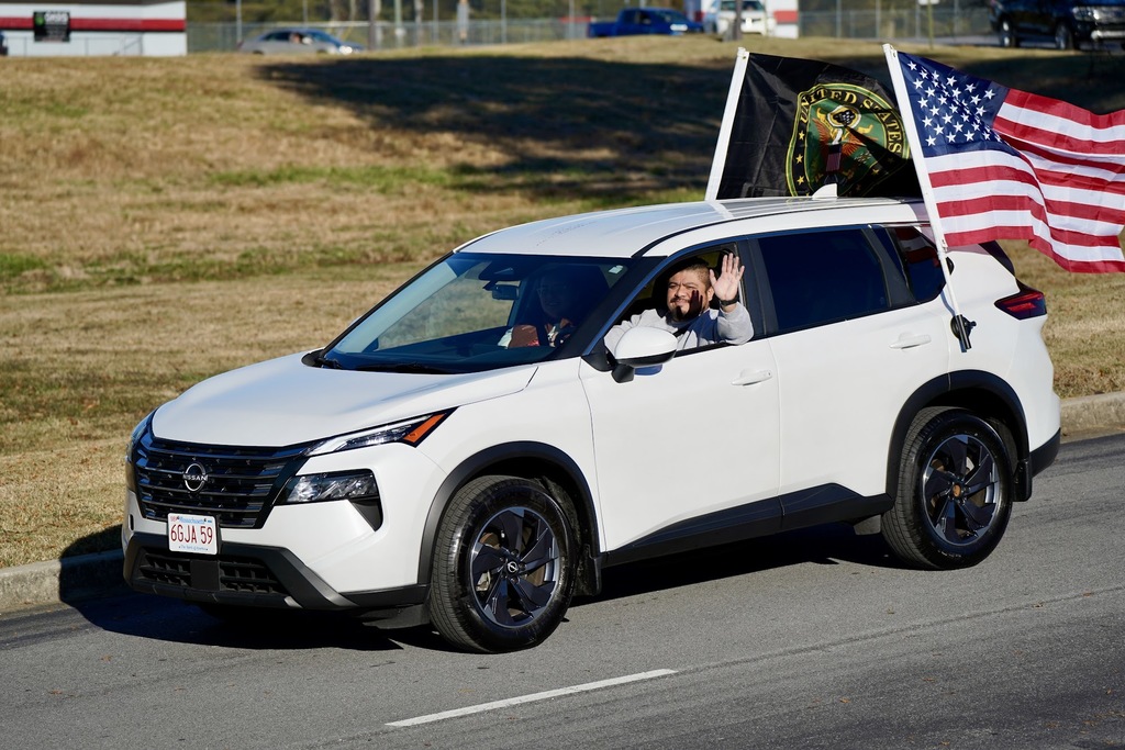 A waving man in a white SUV.