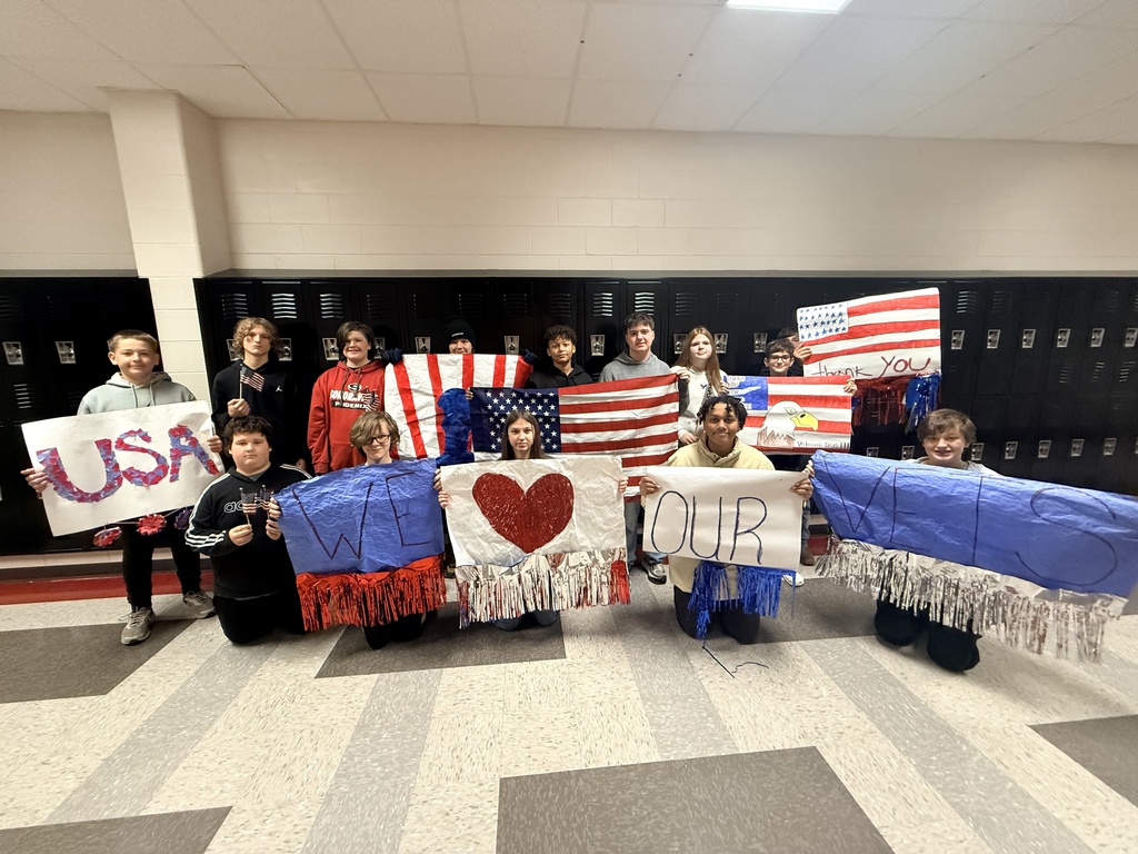 A group of students holding patriotic signs.