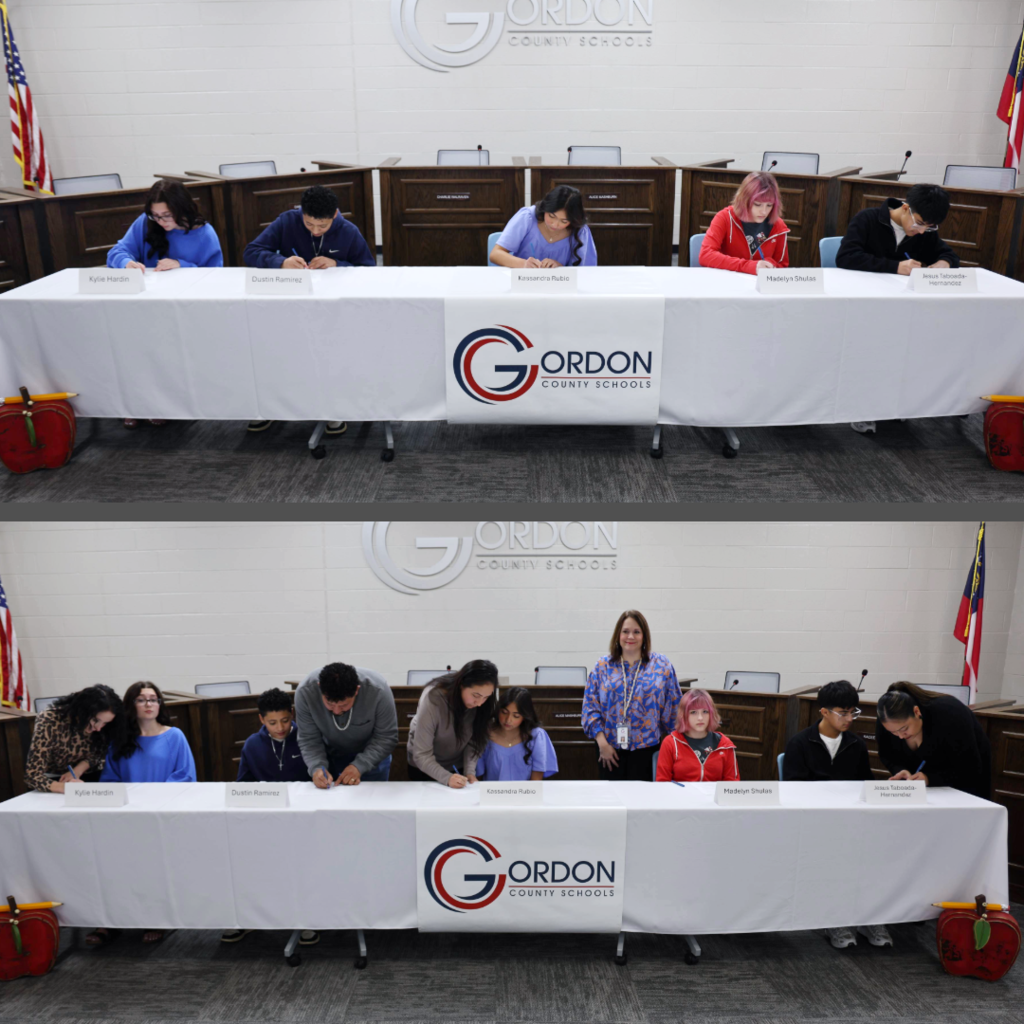 Students and parents signing for REACH Scholars