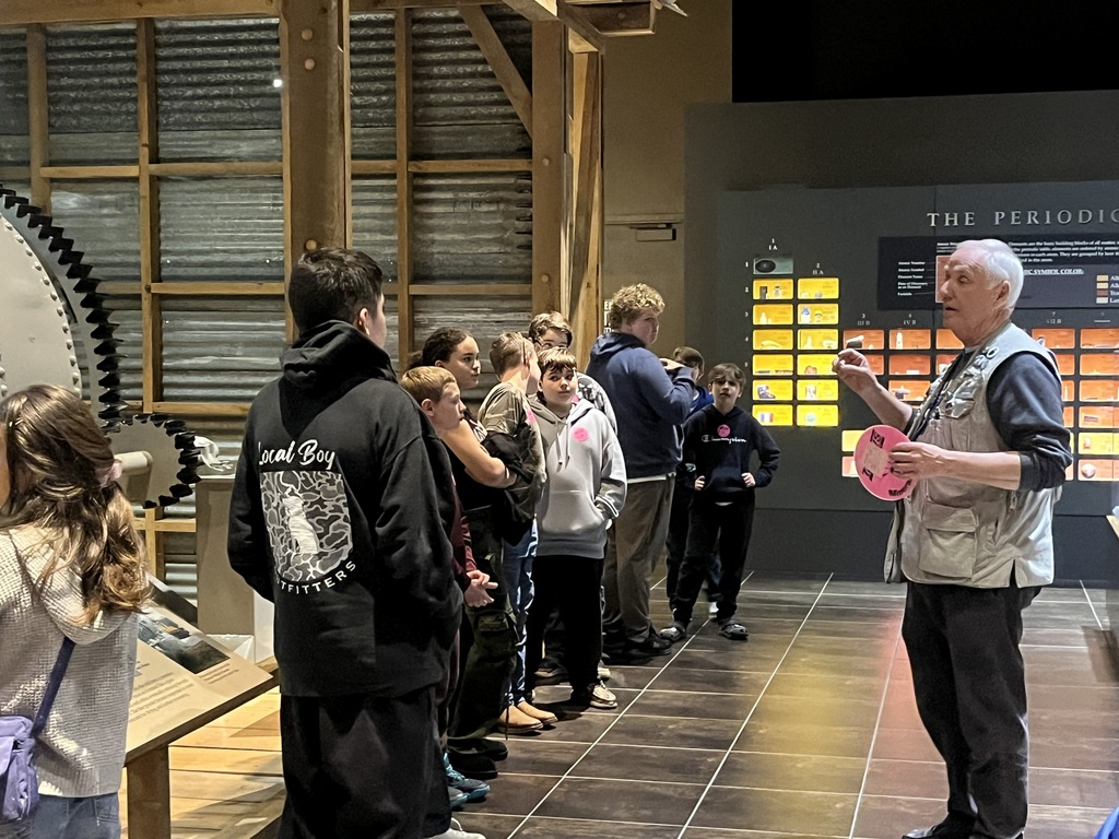 students listening to Tellus Museum tour guide presentation