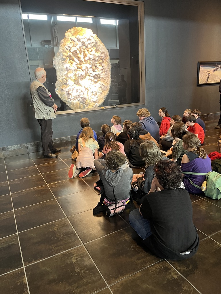 students listening to Tellus Museum tour guide presentation