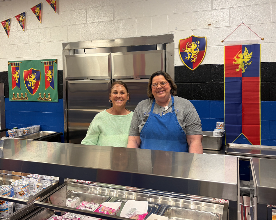 Sket Angland and Amelia Smith serving breakfast during National School Breakfast Week