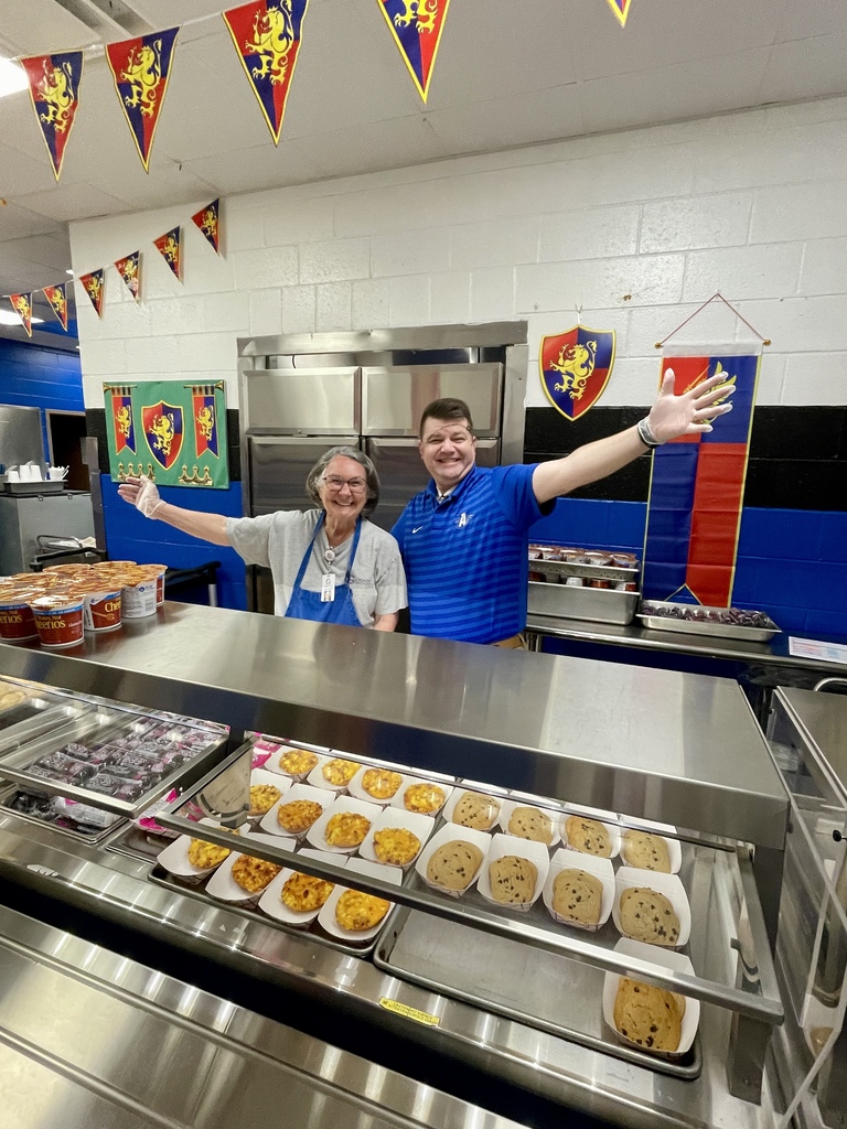 Mr. Danny Lowrance serves breakfast with Annie Faucett, cafeteria staff member, during National School Breakfast Week.