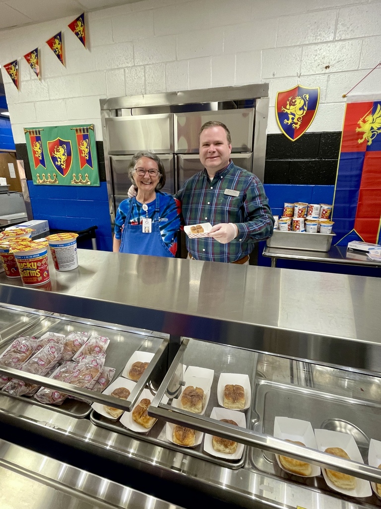 National School Breakfast week celebrity server Justin Timms serving breakfast with cafeteria staff member Annie Faucett