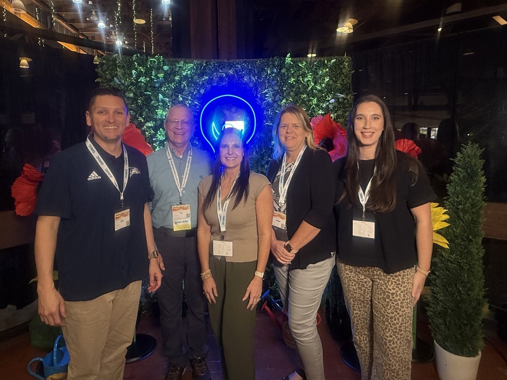 Monica Nacey from W.L. Swain Elementary, Belinda Smith from Tolbert Elementary, Jennifer Farist from Sonoraville Elementary, Matt Wiley from Ashworth Middle School, and Tim Gilreath from Belwood Elementary standing together in front of a dark backdrop