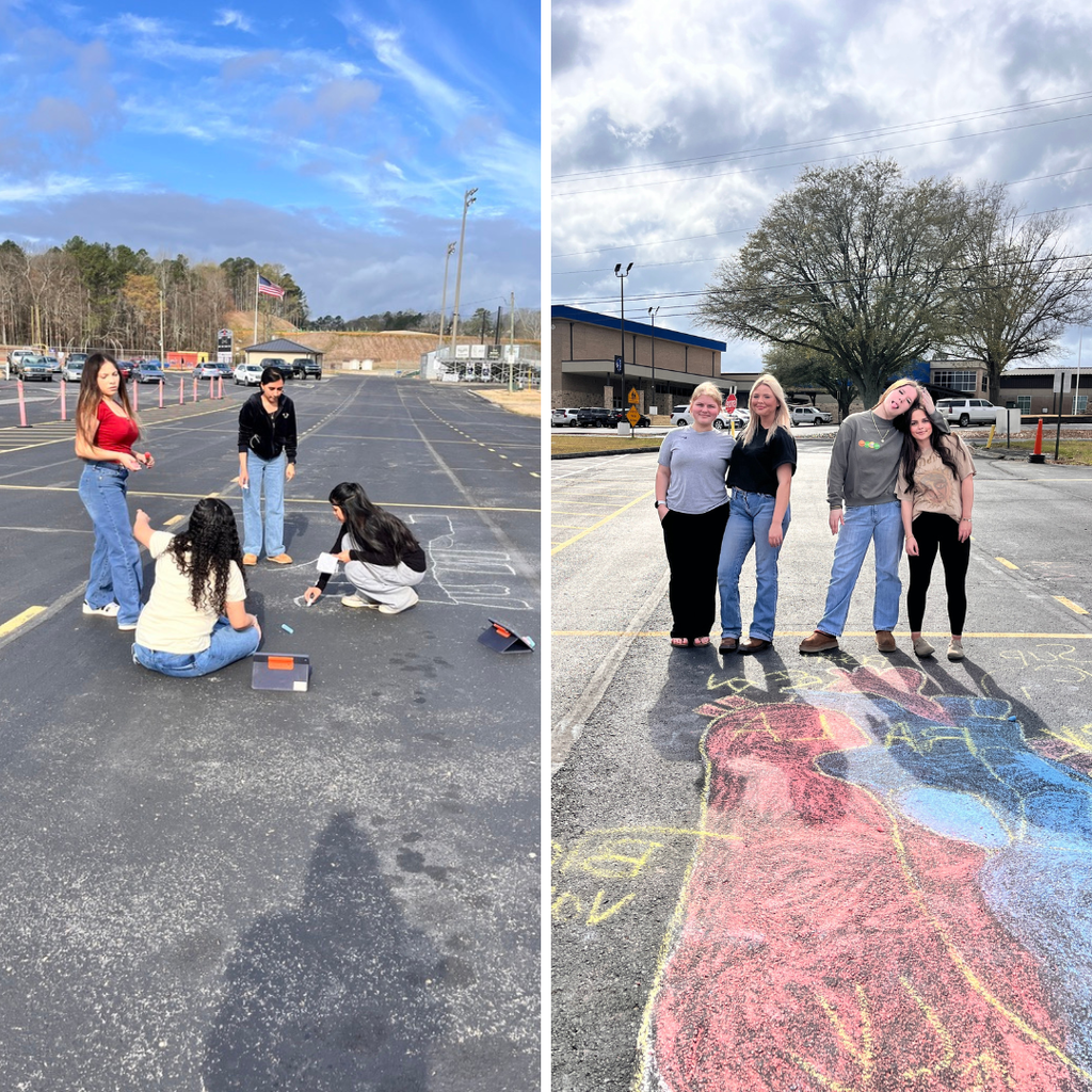 Allied Health students diagramming the heart with chalk in the school parking lot. 