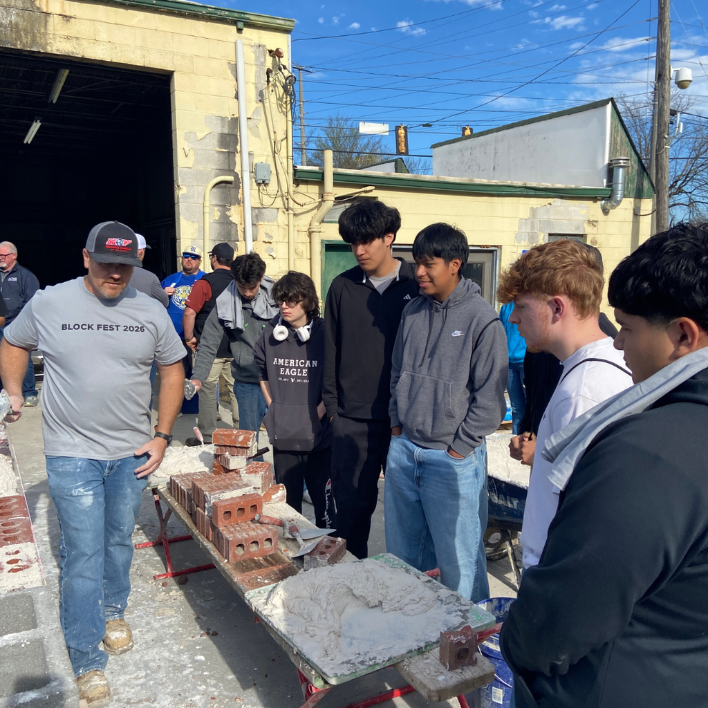 Students seeing demonstration of brick masonry on Block Fest field trip.