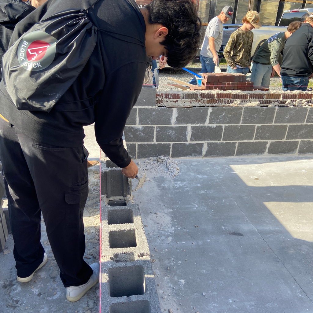 GCHS CTAE students viewing construction site using concrete blocks.