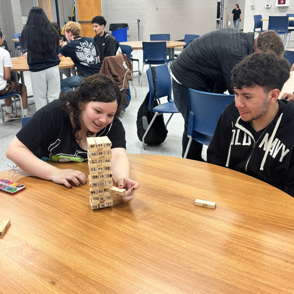 Two 12th Graders playing Jenga against each other