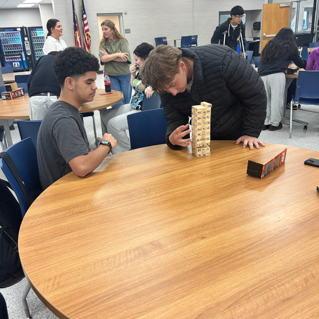 Two 10th graders playing Jenga against each other