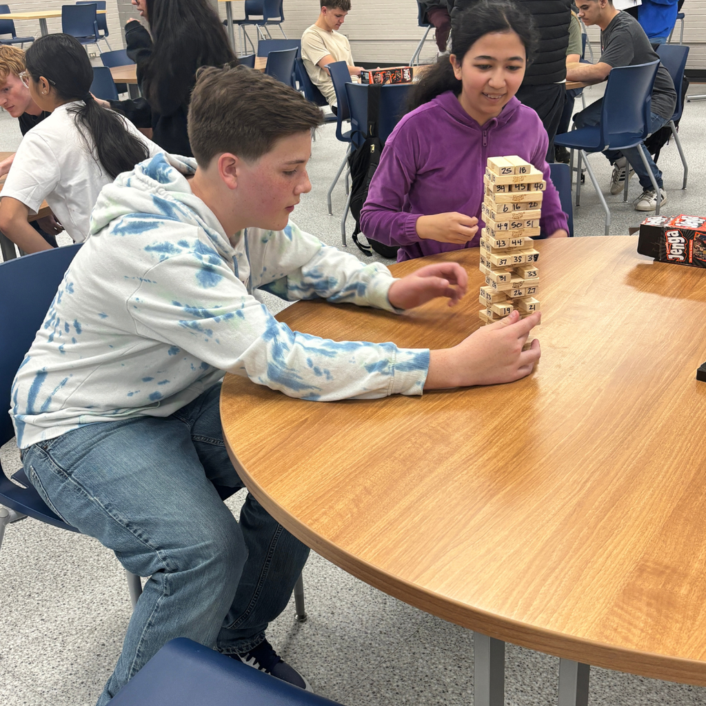 Two freshmen playing Jenga against each other
