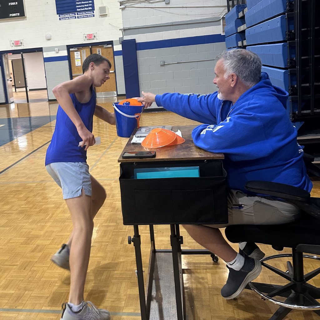 Homeroom rep picking up item in the gym for the scavenger hunt