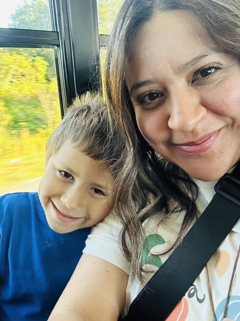 A candid moment of a paraprofessional interacting with students, showing patience and care while supporting their learning.