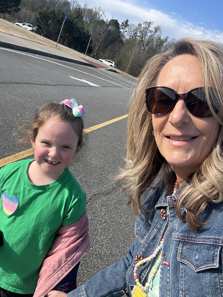 A candid moment of a paraprofessional interacting with students, showing patience and care while supporting their learning.