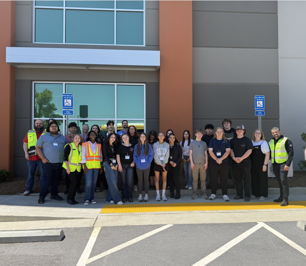 Students standing in front of EAE distribution center.