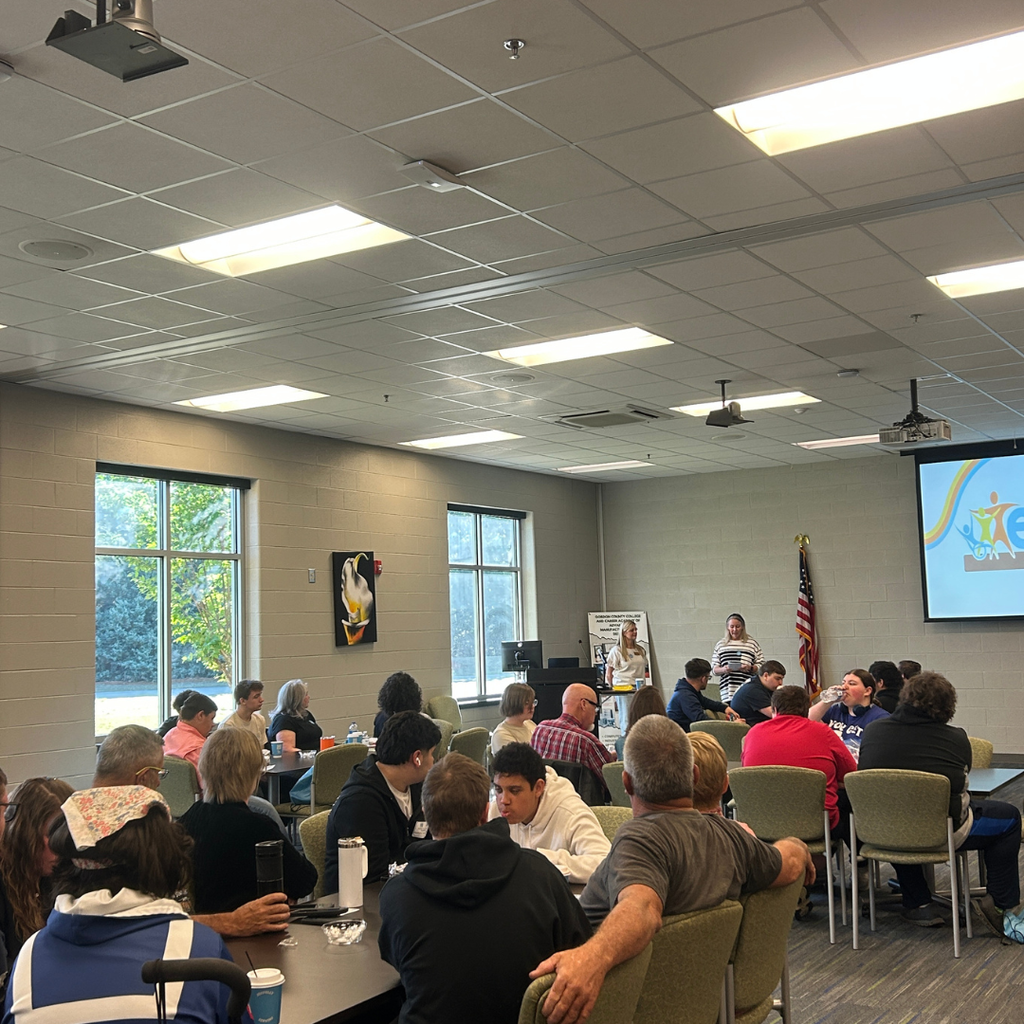 Picture of students, parents and teachers at GA CTI Transition Fair with presenters