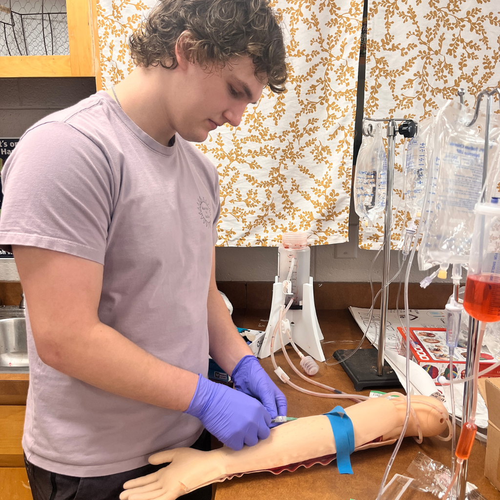 Allied Health student learning to do IV insertion