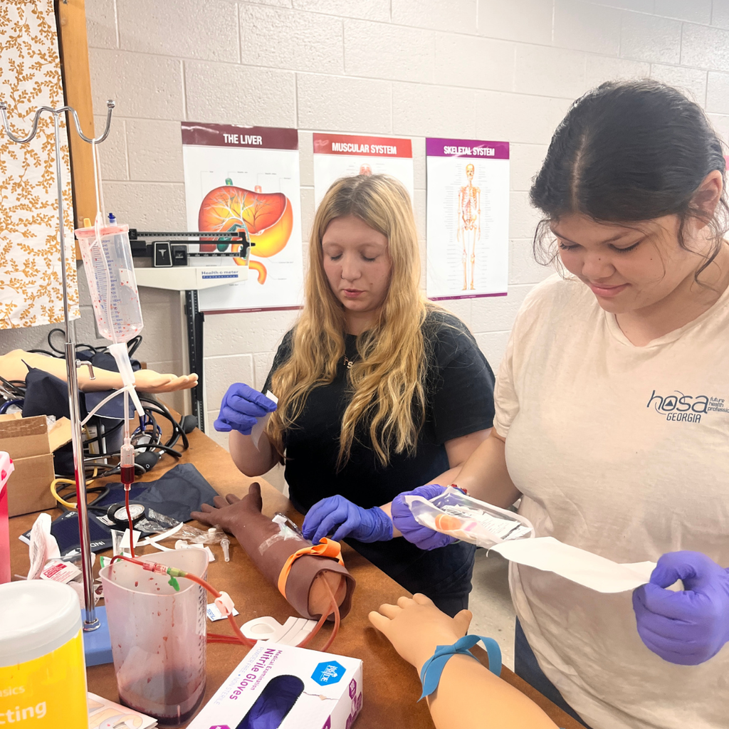 Allied Health student learning to do IV insertion