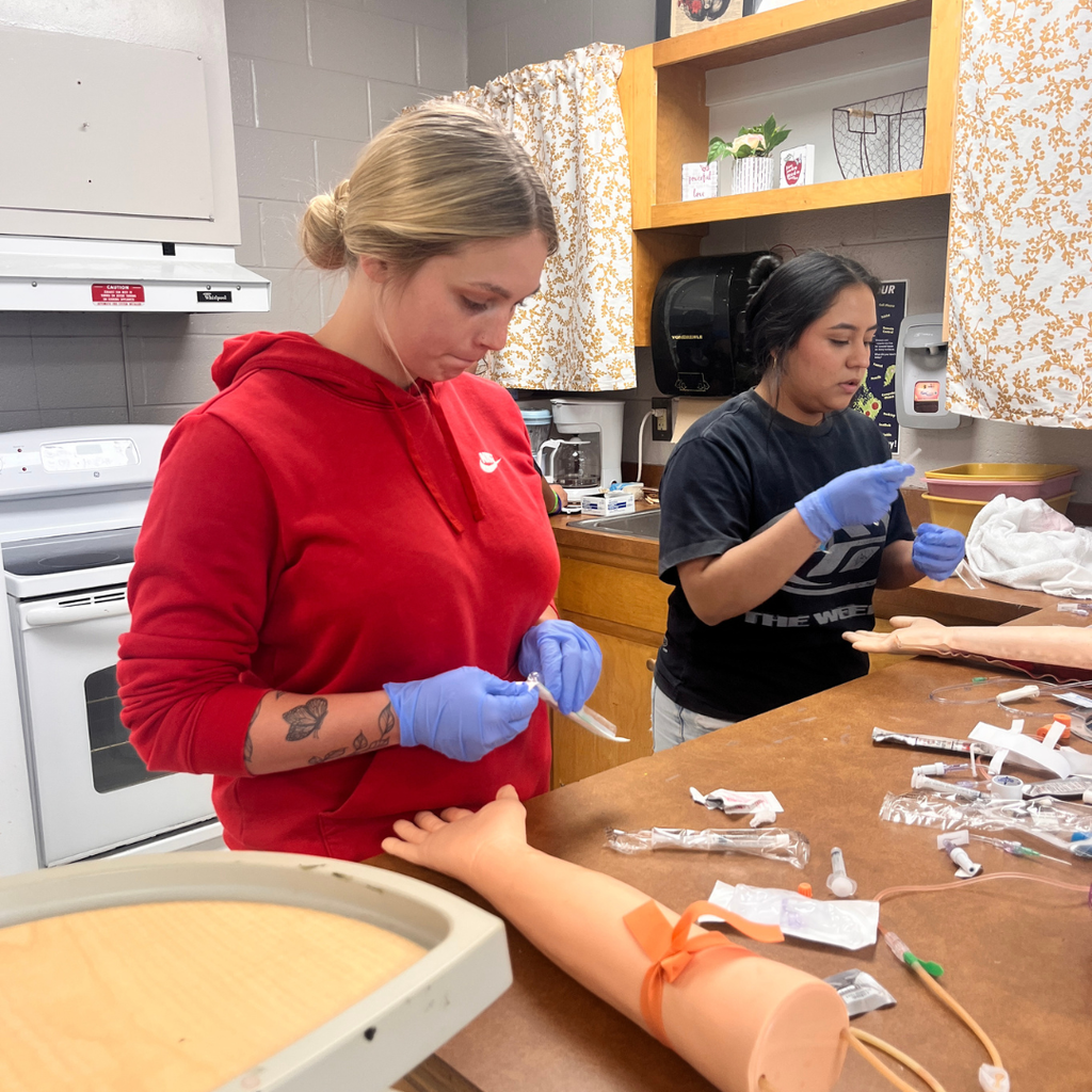 Allied Health student learning to do IV insertion