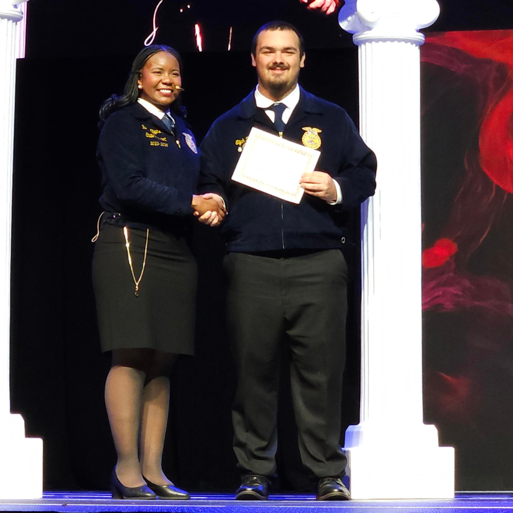 Elijah Bozeman receiving his state FFA degree at the state FFA convention