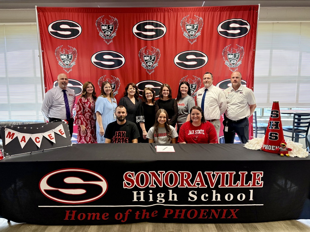 An image of Macee Clark with the SHS Admin Team and Cheer coaches celebrating her signing with Jax State.