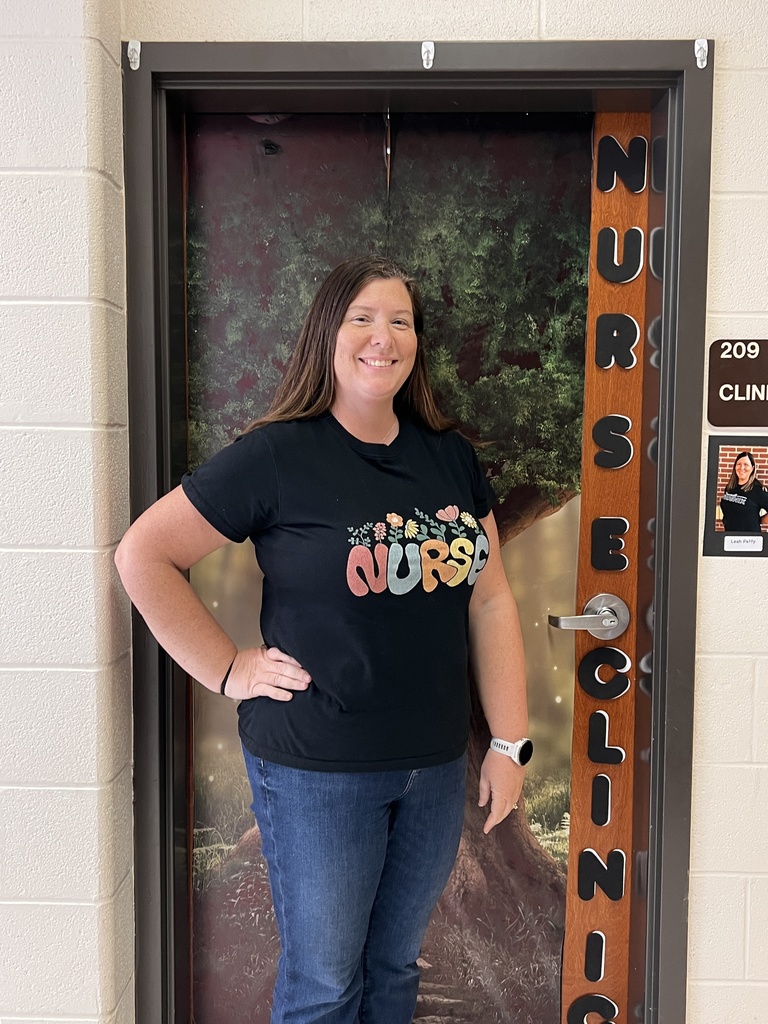 School Nurse, Leah Petty, stands in front of the nurses clinic door. 