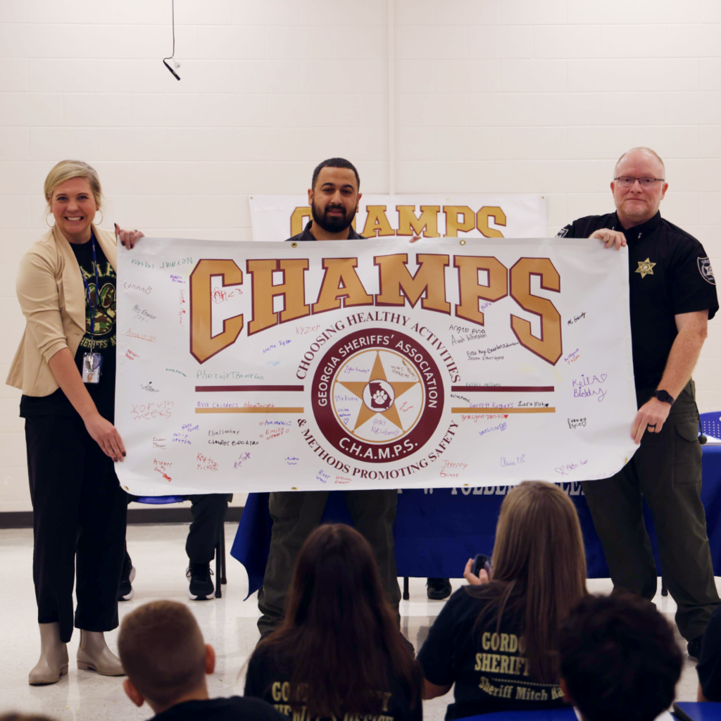 People holding the CHAMPS banner