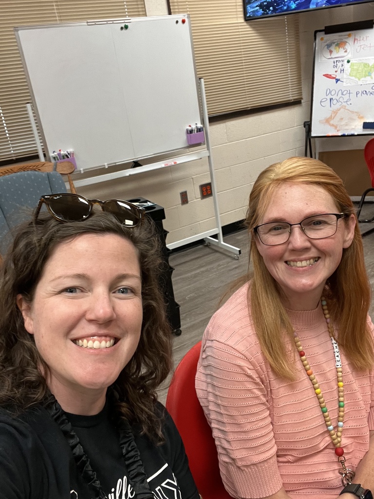 Two support teachers smiling at the camera