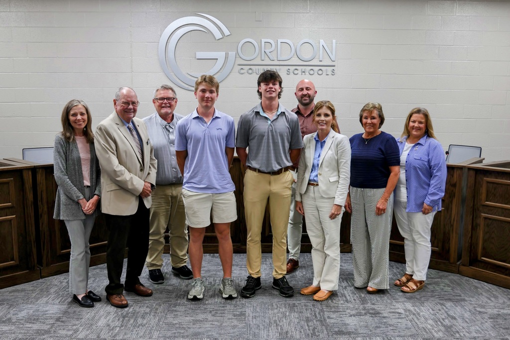 The Board of Education, Mrs. Mashburn, and Chapel Parr with Hudson Kinman