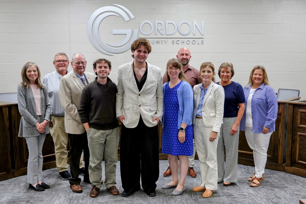 The Board of Education, Mrs. Mashburn, and students Ethan Smith and Blake Carey, with Hannah Nelson