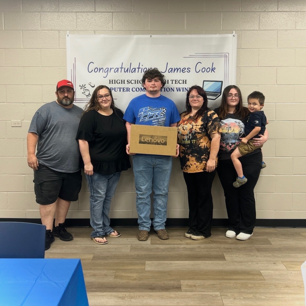 Photo of James Cook and family with computer that he won for HSHT Computer Competition