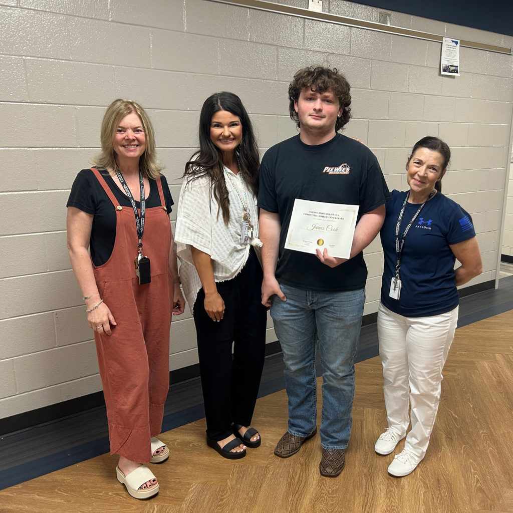 Photo of Ms. Lena Freeman, Ms. Maci Mills, James Cook and Ms. Valerie Allen when James Cook was awarded the computer for winning the HSHT computer competition