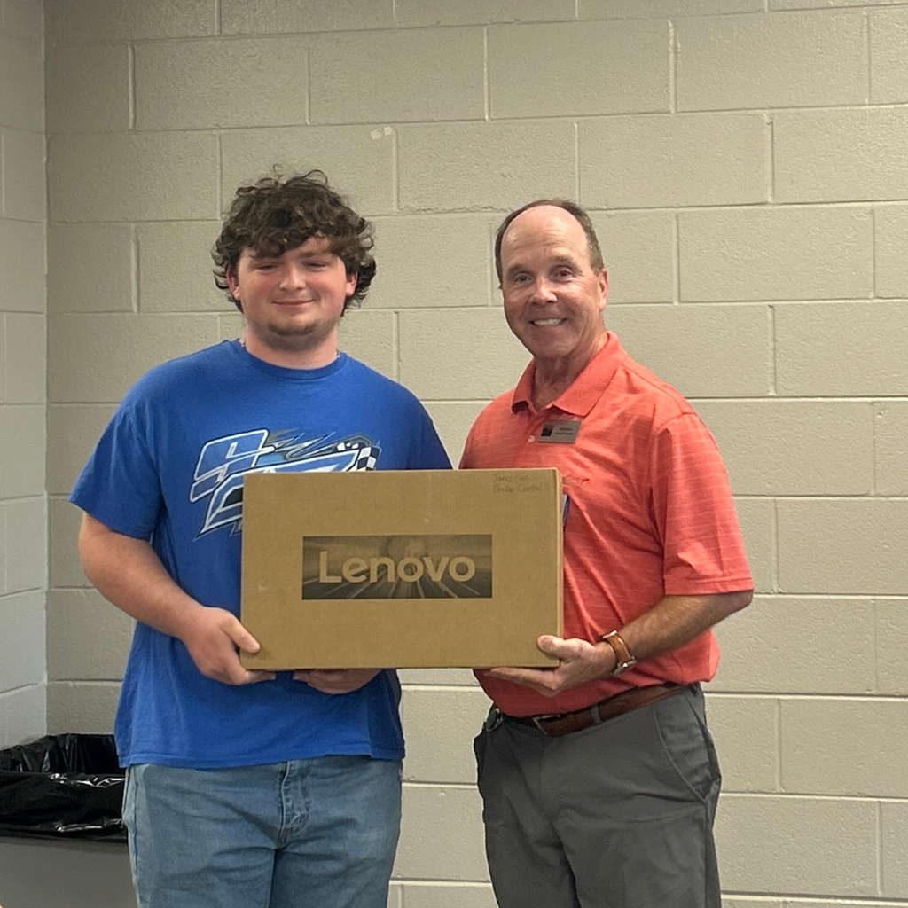Photo of Mr. Robert Pipkin with James Cook when he received the computer for winning the HSHT computer competition