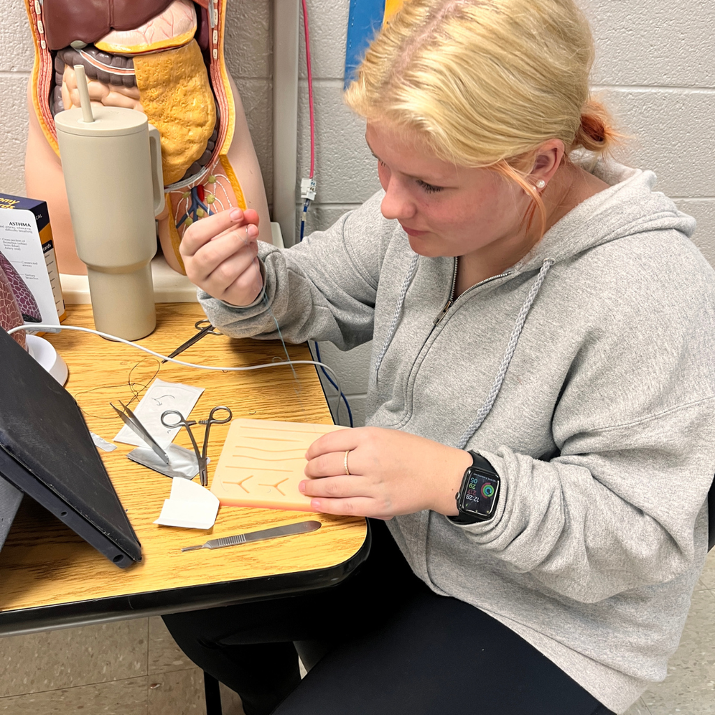 Future healthcare professionals in action! 🩺✂️ Mrs. Lee's Allied Healthcare students are learning about surgical incisions, wounds, and sterile technique. Today, they put their knowledge into practice by using skin pads to learn basic suturing skills. For a first-time experience, they did an amazing job!