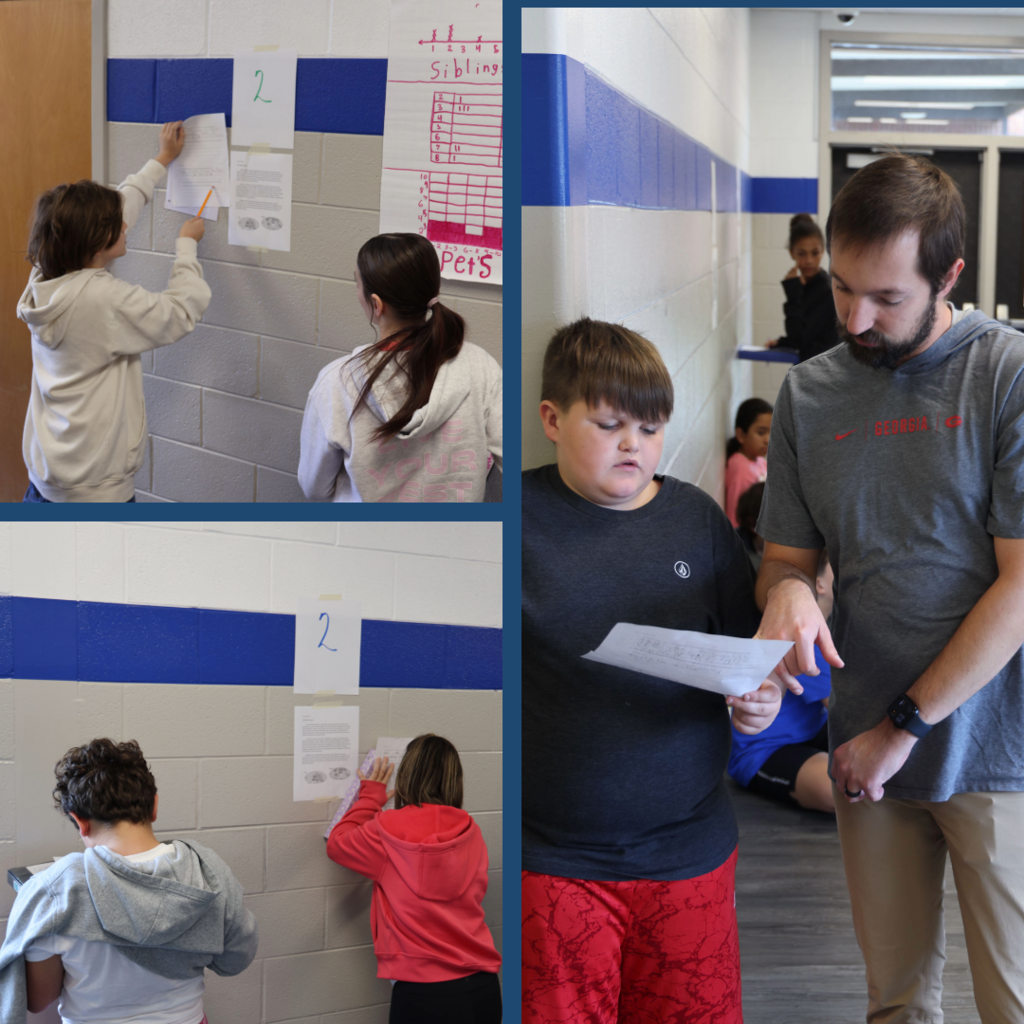 Students analyzing documents and writing answers on worksheets in the hallway.