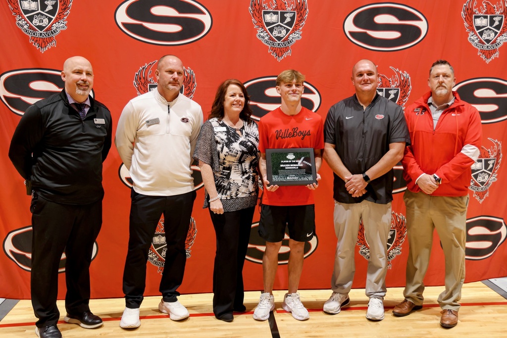 Ceremony honoring Braxen for winning state football player of the week. Posing with administration team