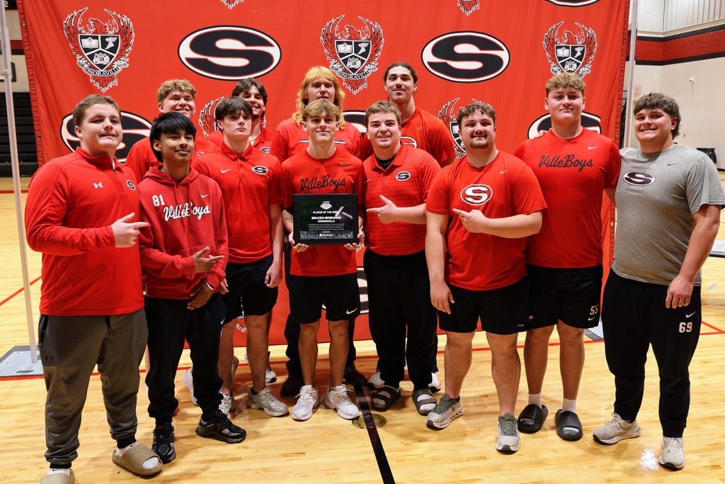 Ceremony honoring Braxen for winning state football player of the week. Posing with teammates
