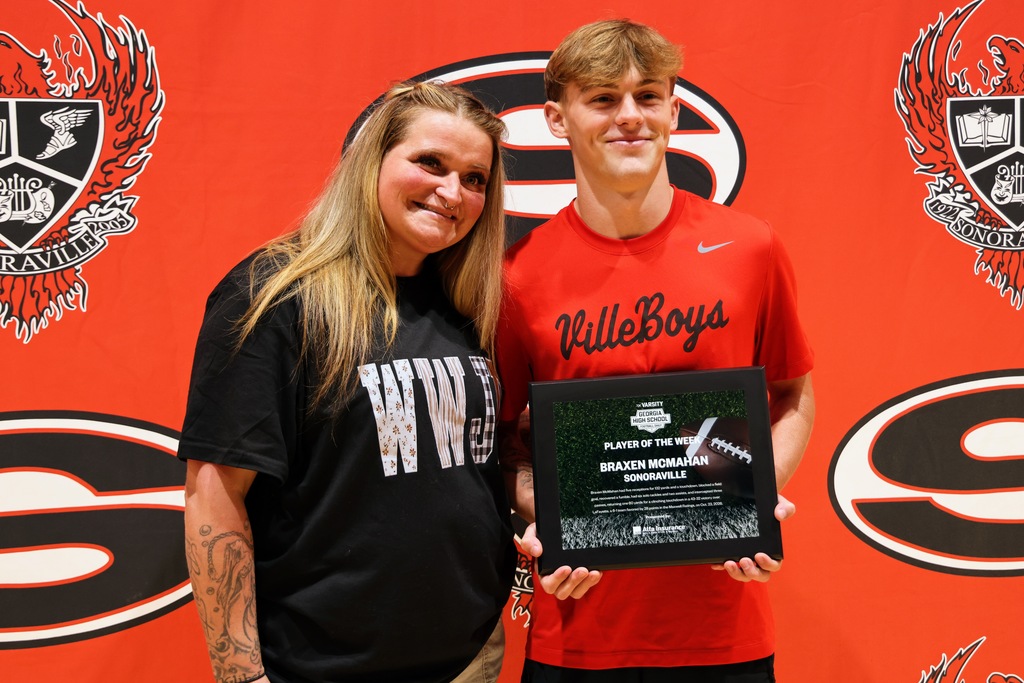 Ceremony honoring Braxen for winning state football player of the week. Posing with mom