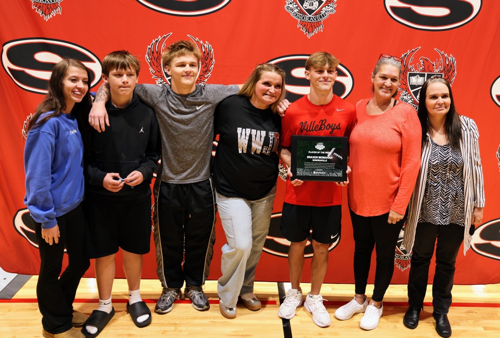 Ceremony honoring Braxen for winning state football player of the week. Posing with family