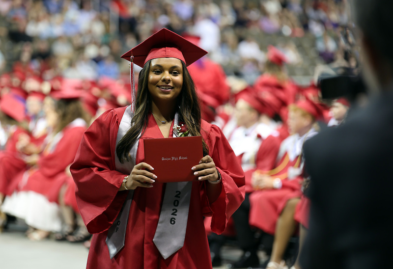 female student holding diploma