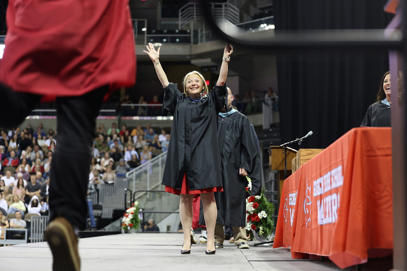 female adult lifting arms in celebration