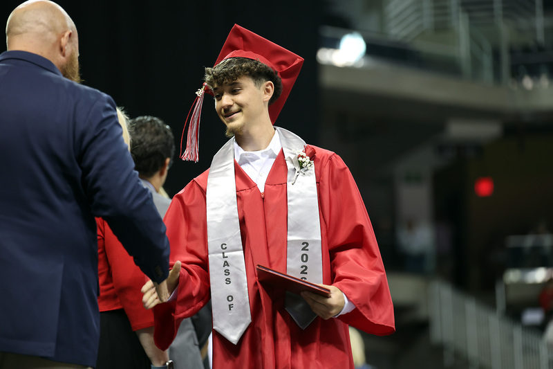 male grad accepting diploma