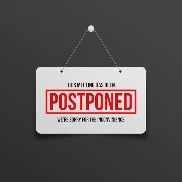 Dark background with light colored poster announcing meeting postponed
