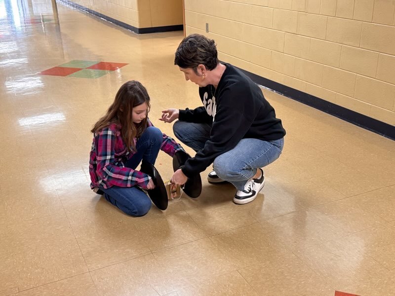 Mrs Setty helping student set car up
