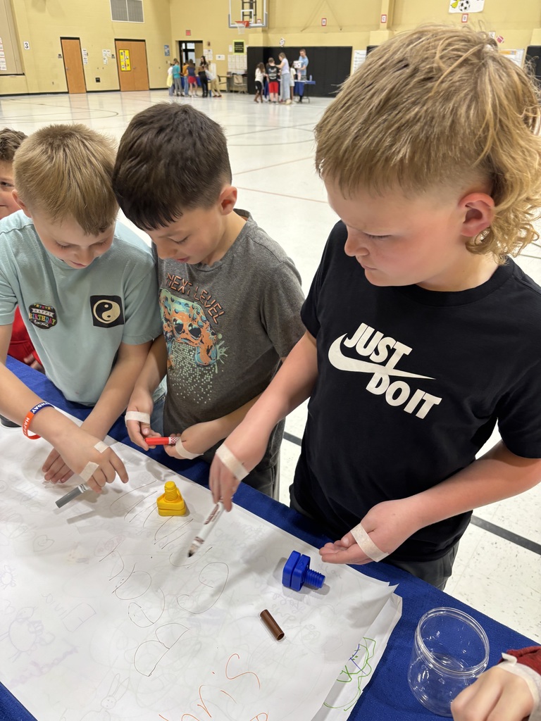 Students seeing what it might be like to work without their thumbs.